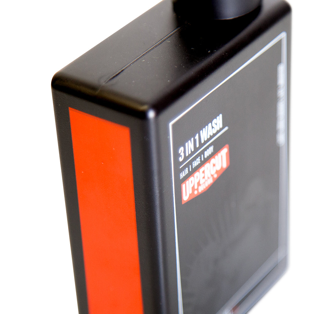 Uppercut Deluxe 3 in 1 Wash 240 ml — 240 ml bottle angled, showing the orange label band
