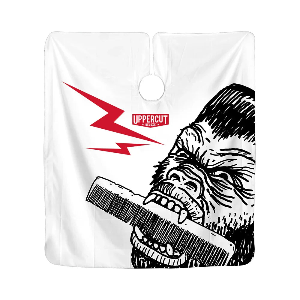 Uppercut Deluxe Barber Cape - Groomzilla — white barber cape hung flat, Groomzilla gorilla and red lightning artwork, white background