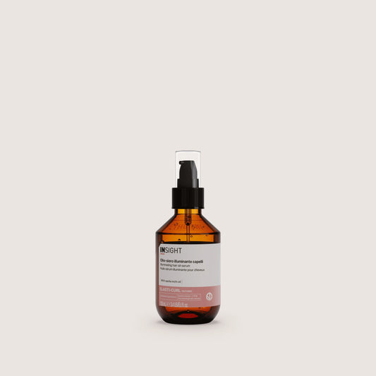 Insight Illuminating Hair Oil - Serum 100ml — official brand packshot of the current 100 ml package, amber bottle with black pump and clear over-cap, front label facing camera, warm beige background