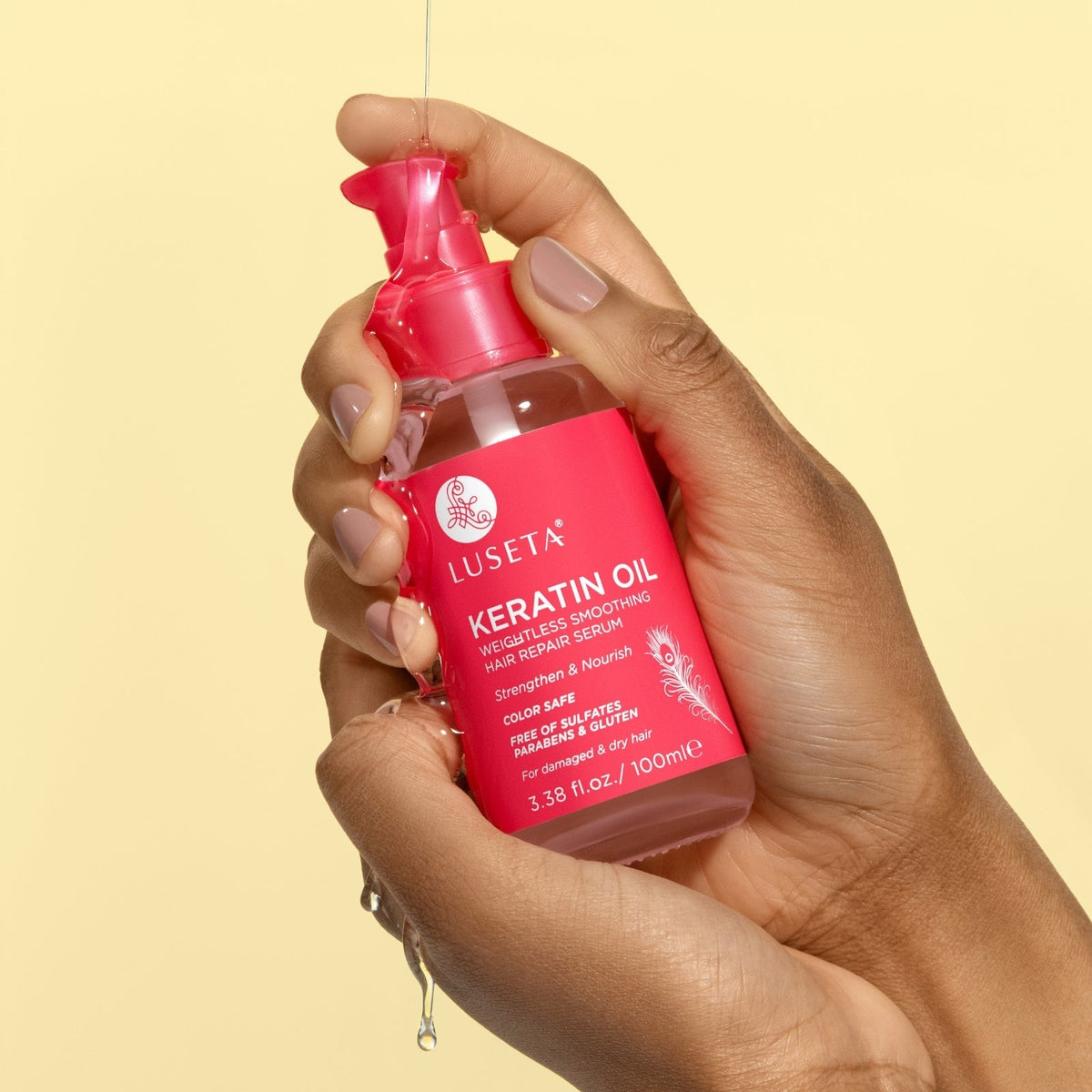 Luseta Beauty Keratin Oil Hair Repair Serum — 3.38 fl oz / 100 ml pink bottle held in hand, front label