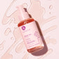Luseta Beauty Rose Oil Hair Serum - 3.38 fl oz / 100 ml bottle on pink serum swirl