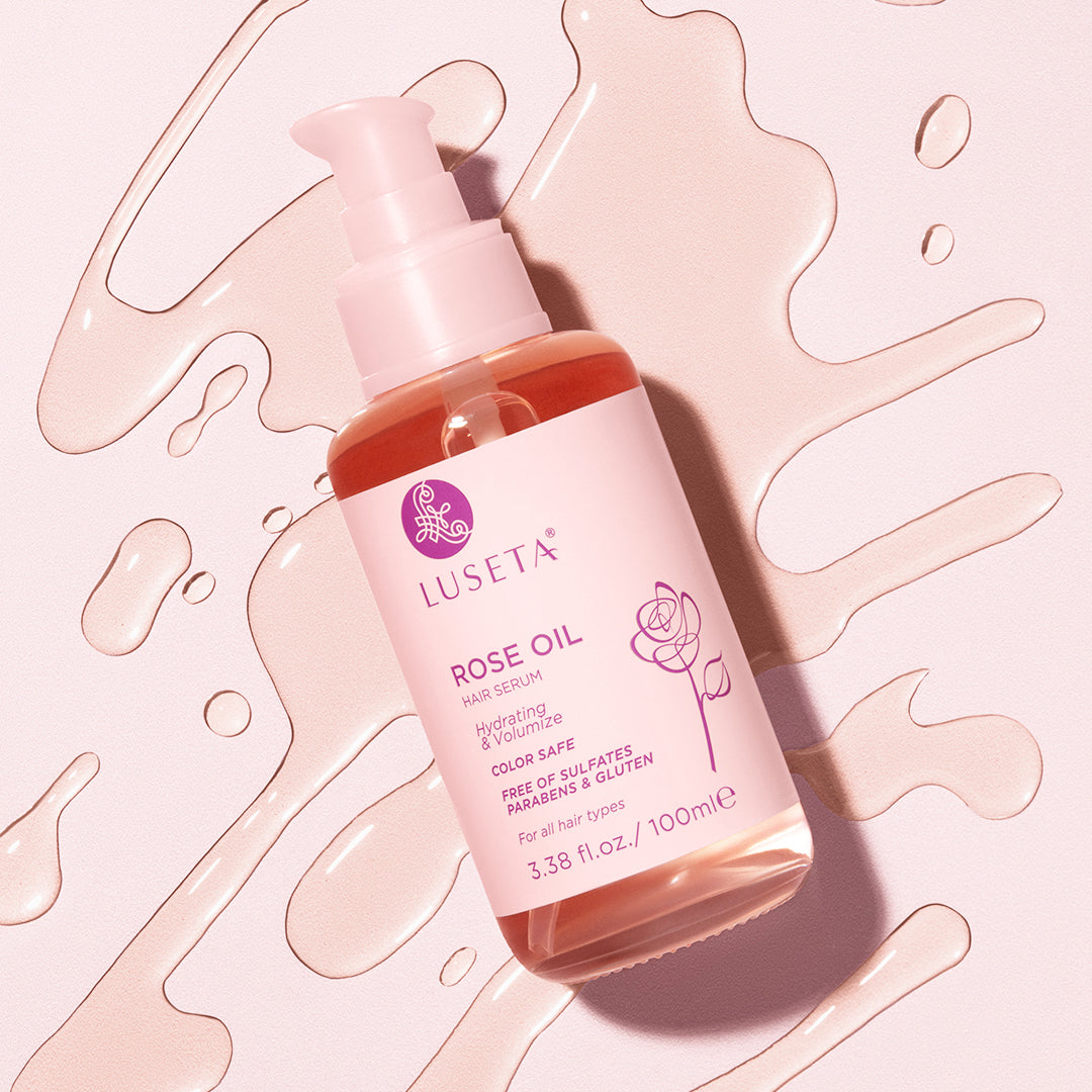 Luseta Beauty Rose Oil Hair Serum - 3.38 fl oz / 100 ml bottle on pink serum swirl