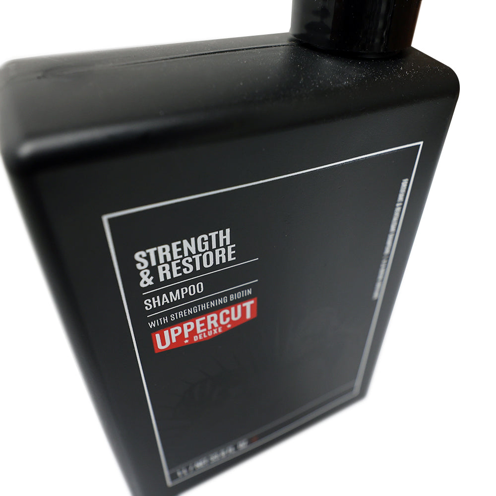 Uppercut Deluxe Strength & Restore Shampoo — 1 L bottle angled, showing the label detail