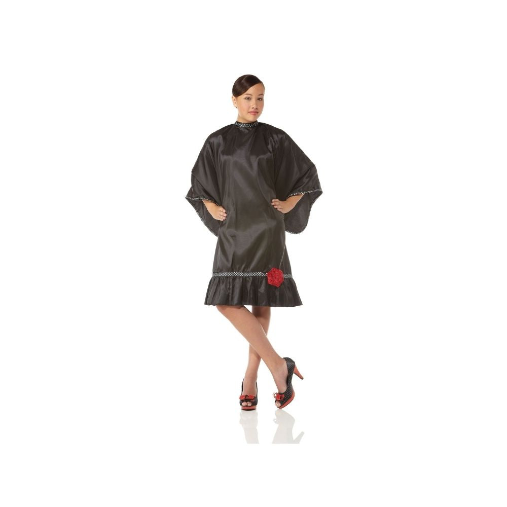 Olivia Garden Boutique black salon cape with its red flower clasp, shown worn, on a plain white background