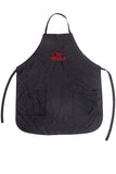 Wella Professionals Salon Apron — black water-repellent colour apron with red Wella Professionals logo and two front pockets, laid flat on white
