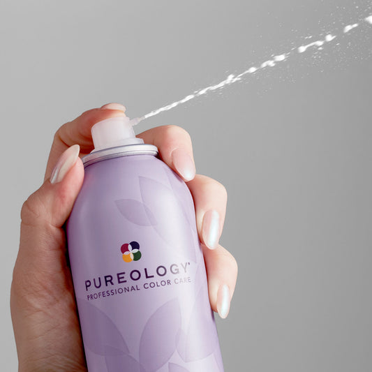 Pureology Style + Protect On the Rise Root-Lift Mousse — hand holding the can while dispensing the mousse