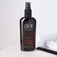 American Crew Prep & Prime Tonic — 250 ml spray bottle beside a comb on a white counter
