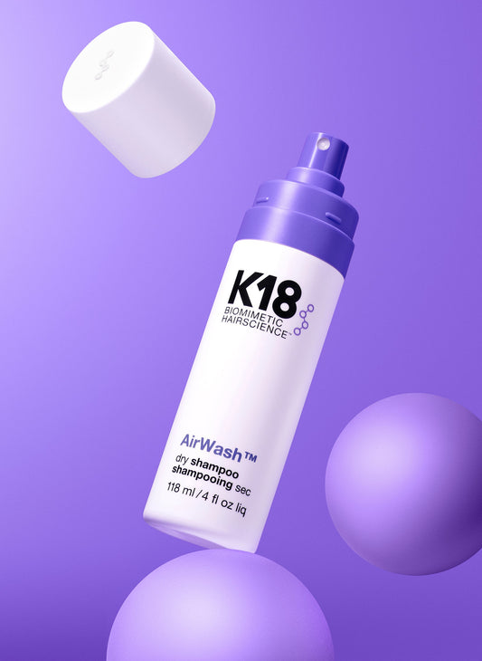 K18 AirWash Non-Aerosol Dry Shampoo — 4 oz bottle with cap removed, floating studio shot
