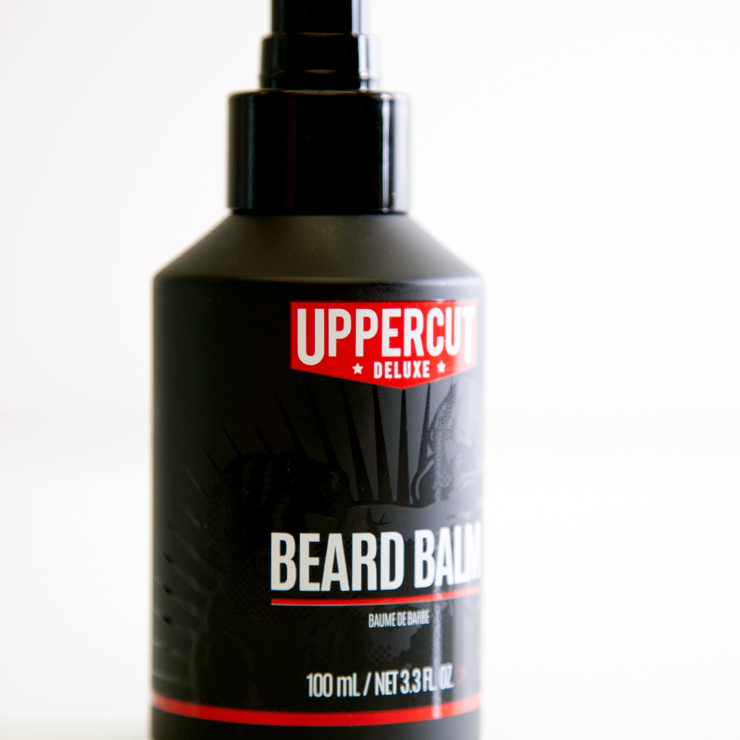 Uppercut Deluxe Beard Balm 100 ml — black 100 ml beard balm bottle angled, showing the pump top