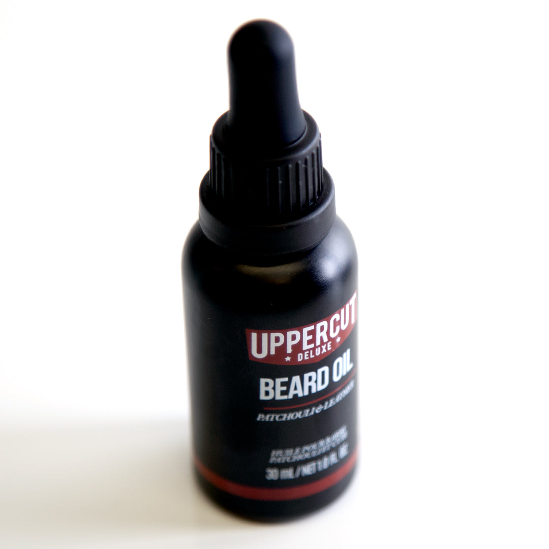 Uppercut Deluxe Beard Oil 30 ml — 30 ml beard oil bottle angled with the dropper in place