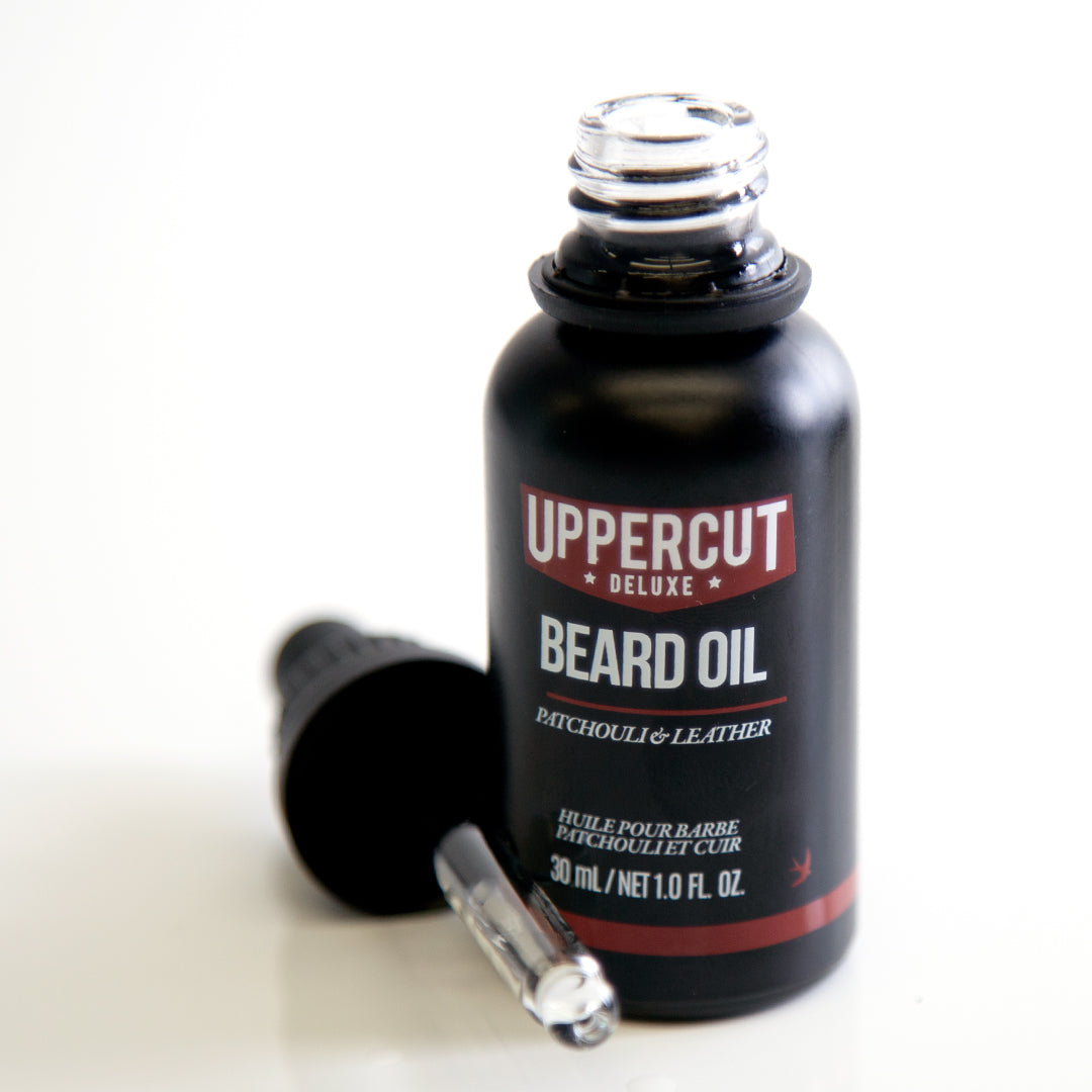 Uppercut Deluxe Beard Oil 30 ml — 30 ml beard oil bottle open beside its glass dropper