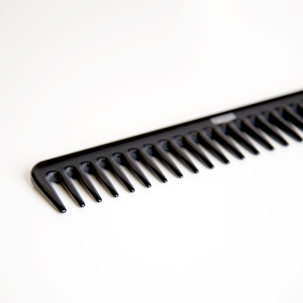 Uppercut Deluxe CB11 Rake Comb — black rake comb angled, showing the tooth spacing