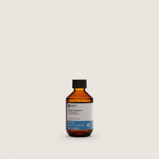 Insight Energizing Shampoo 100ml — official brand packshot of the current 100 ml package, amber bottle, front label facing camera, warm beige background