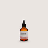 Insight Illuminating Hair Oil - Serum 100ml — official brand packshot of the current 100 ml package, amber bottle with black pump and clear over-cap, front label facing camera, warm beige background