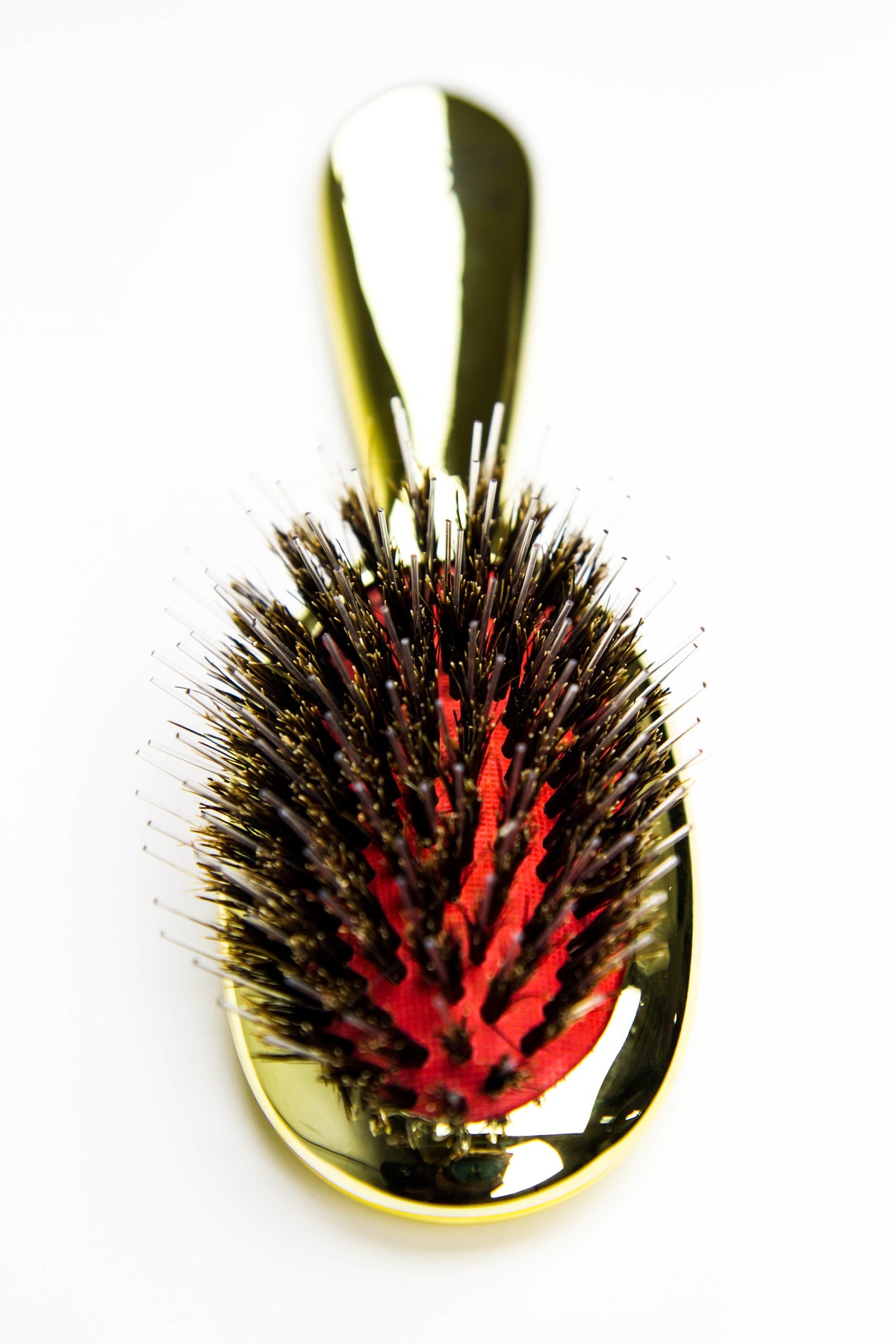 Reuzel x Franco & Co Metallic Cushion Blow-Dry Brush — gold metallic cushion brush with mixed boar and nylon bristles and the Franco & Co hand logo, front view on white