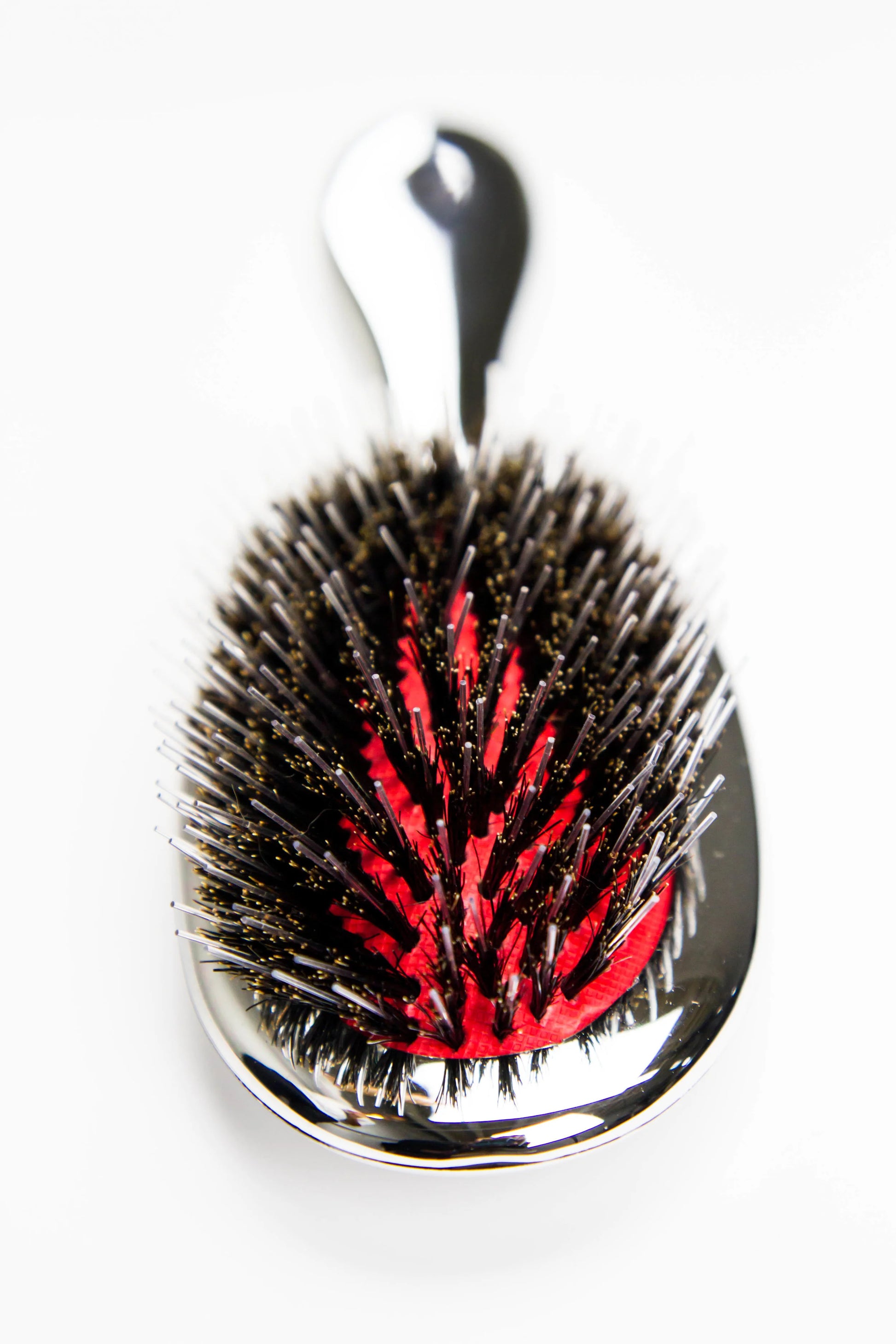 Reuzel x Franco & Co Metallic Cushion Blow-Dry Brush — silver metallic cushion brush with mixed boar and nylon bristles and the Franco & Co hand logo, front view on white