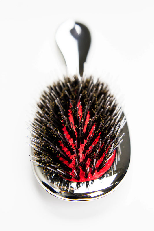 Reuzel x Franco & Co Metallic Cushion Blow-Dry Brush — silver metallic cushion brush with mixed boar and nylon bristles and the Franco & Co hand logo, front view on white