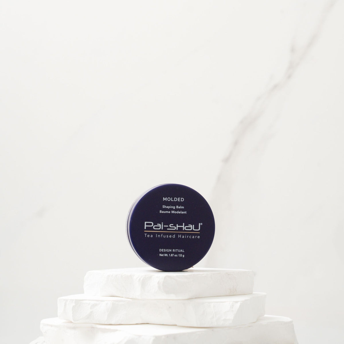 Pai-Shau Shaping Balm — Molded shaping balm jar on a white plinth