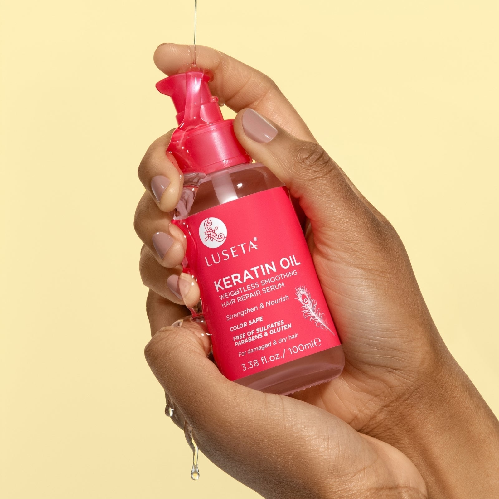 Luseta Beauty Keratin Oil Hair Repair Serum — 3.38 fl oz / 100 ml pink bottle held in hand, front label