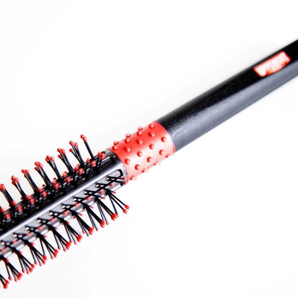 Uppercut Deluxe Quiff Roller Brush — close-up of the rubber non-slip grip handle