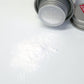 Uppercut Deluxe Styling Powder — tin on its side with the loose powder shown