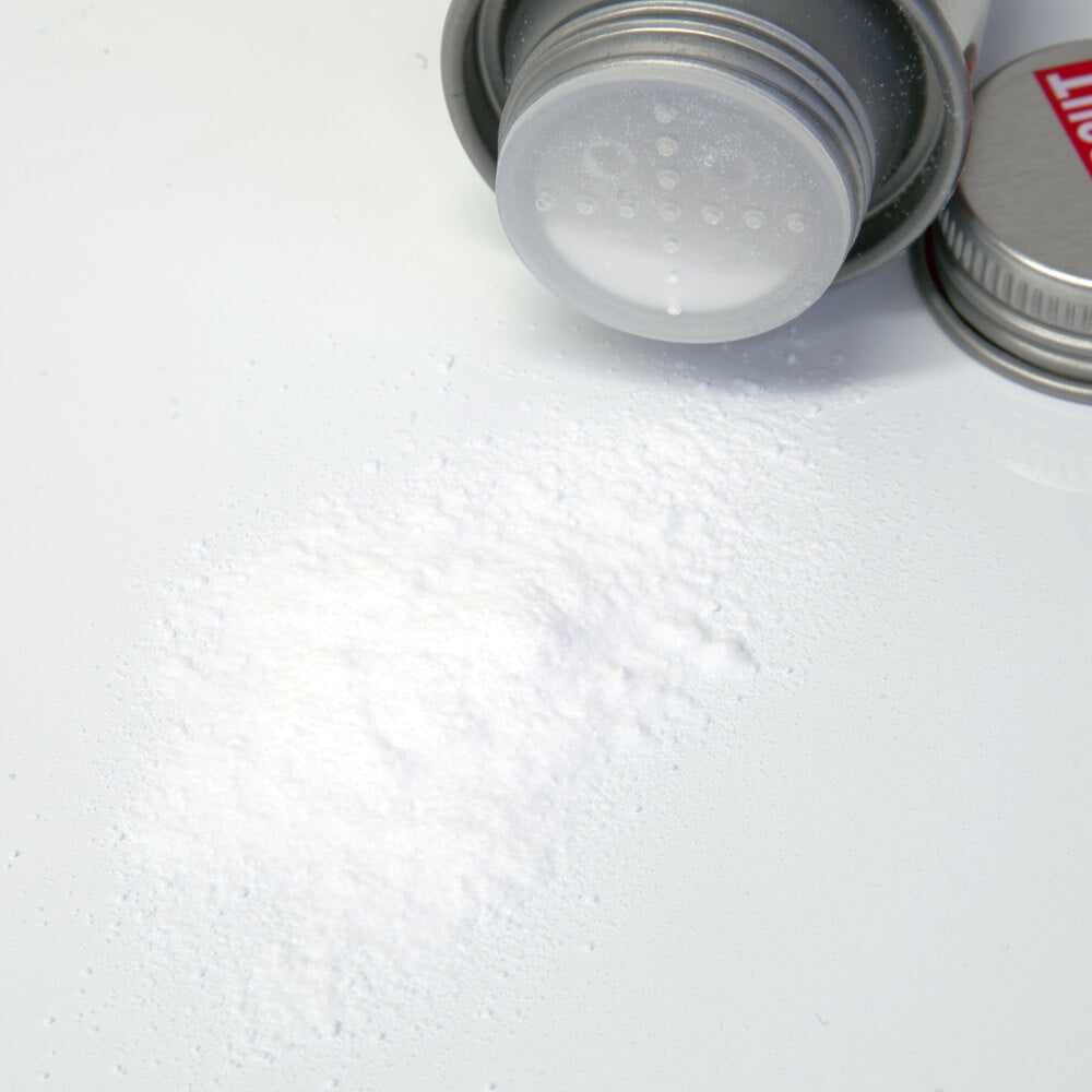 Uppercut Deluxe Styling Powder — tin on its side with the loose powder shown