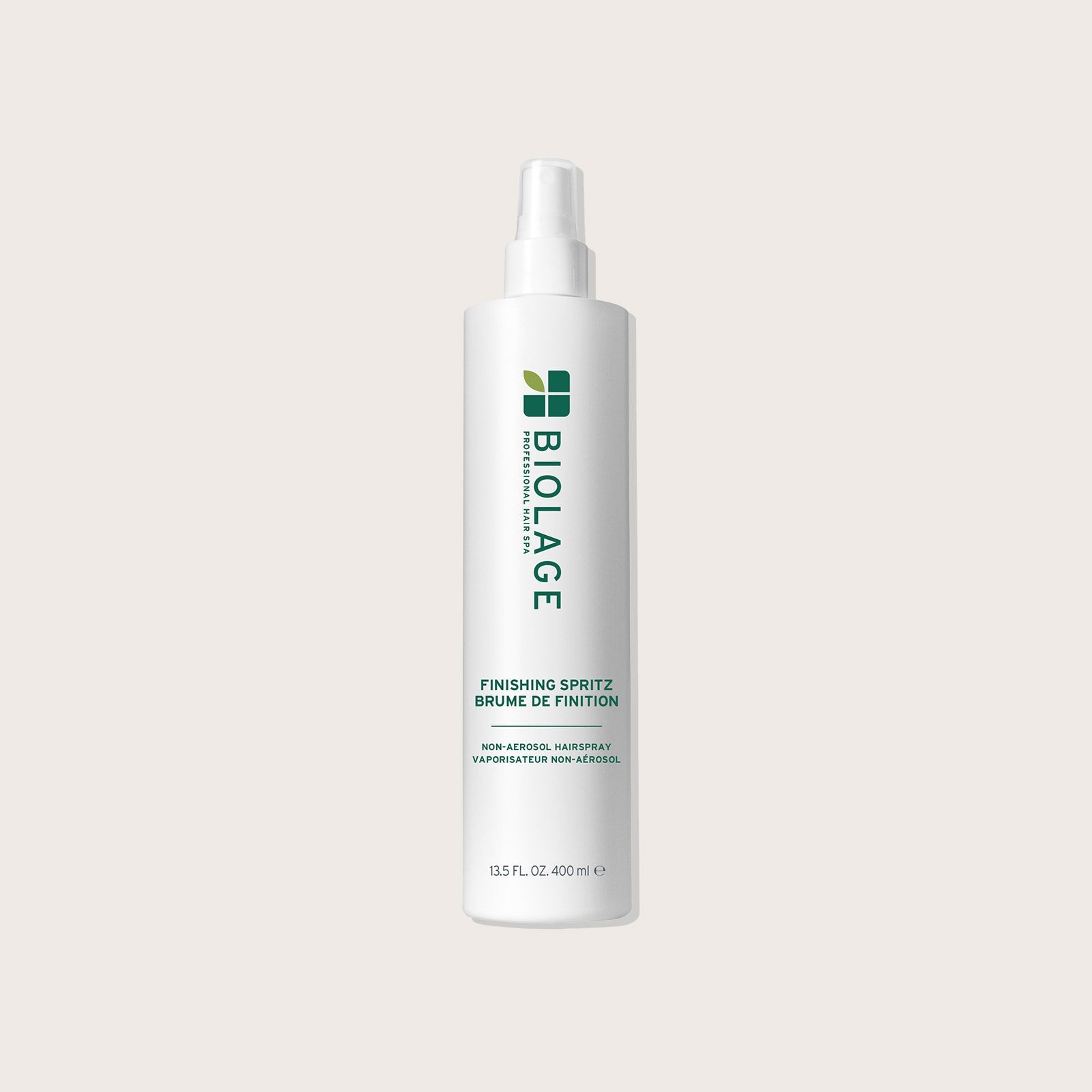 Biolage Finishing Spritz 400 ml — pump bottle on a warm neutral background
