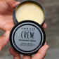 American Crew Grooming Cream — open puck held in a hand, showing the cream inside the tin