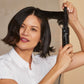 Hot Tools Professional Hot Air Brush in use — curl-release lever and HI/LOW/OFF heat switch visible