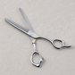 Otto 6-inch Texturizing & Thinning Shears — the thinning shear laid open on a light stone salon surface
