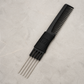 Otto 7.5-inch lift comb with five metal prongs on a light stone salon surface