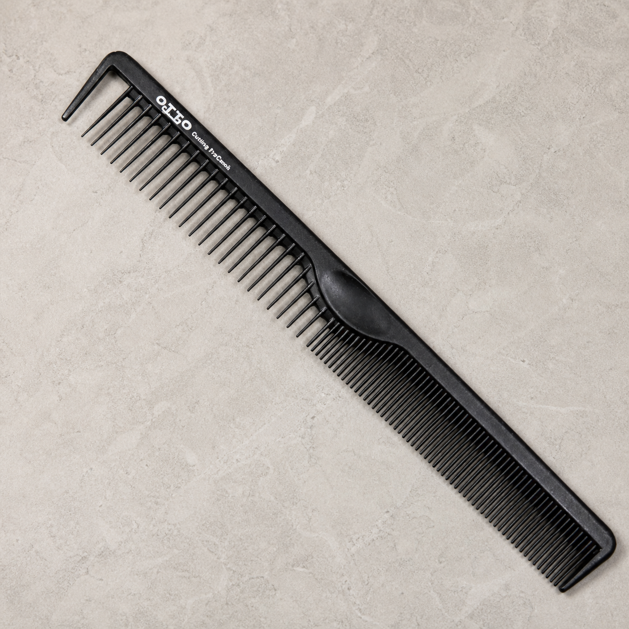Otto 8.5-inch dual-tooth cutting comb on a light stone salon surface