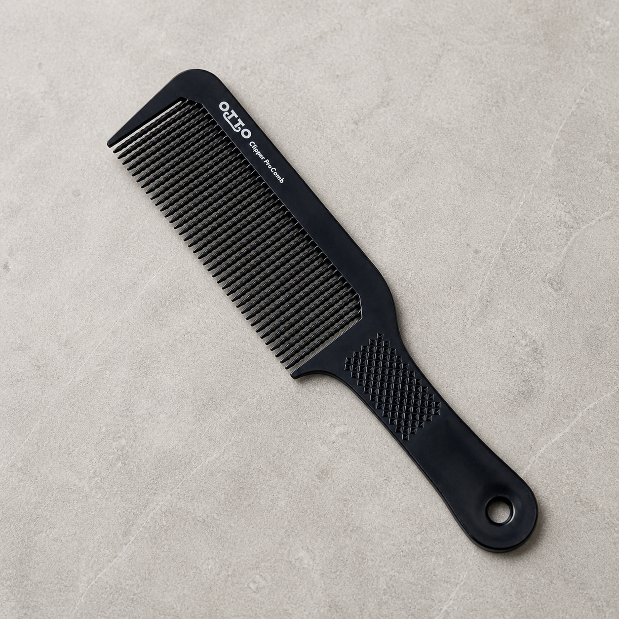 Otto 9.5-inch flat-top clipper comb on a light stone salon surface