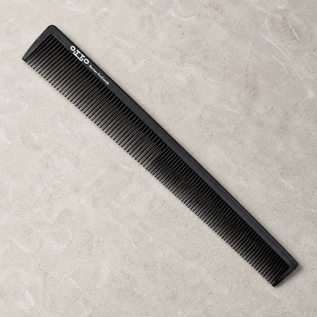 Otto 9-inch dual-tooth barber comb on a light stone salon surface
