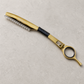 Otto gold guarded haircutting razor on a light stone salon surface