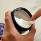 American Crew Whip Lightweight Styling Cream — hand scooping the whipped formula out of the open tub